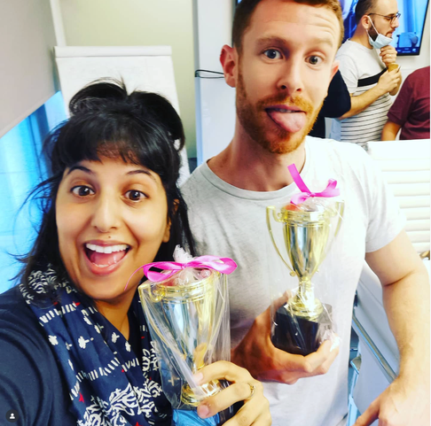 The team celebrating with trophies after the launch.